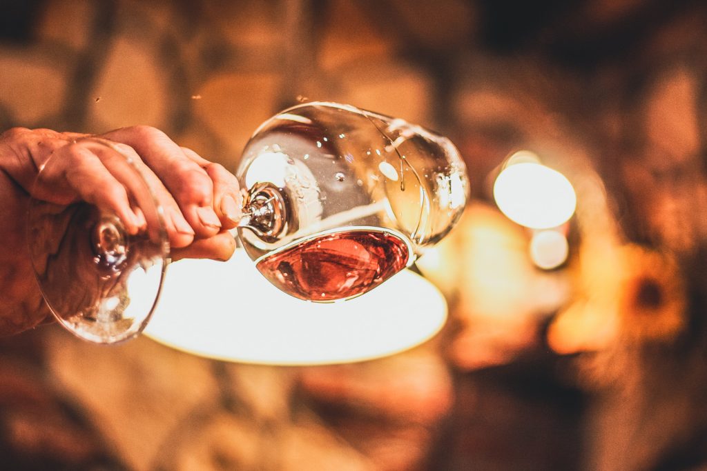 wine glass being held up to a light